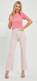 Woman wearing a pink t-shirt and light pink jeans on a white background