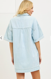 Light blue denim dress worn by a person on a white background
