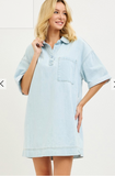 Woman wearing a light blue dress against a white background