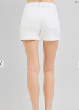 White shorts worn by a person on a gray background