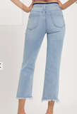 Light blue jeans worn by a person on a white background