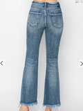 Blue jeans with frayed hem on a white background