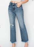 Blue jeans with frayed hems on a white background