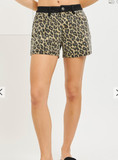 Leopard print shorts worn by a person on a plain background