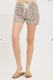 Leopard print shorts worn by a person on a white background