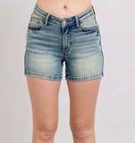 Blue denim shorts on a plain background
