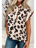 Woman wearing a leopard print blouse with ruffled sleeves against a neutral background