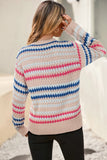 Woman wearing a colorful striped sweater with a blurred background