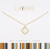 Gold necklace with a clover-shaped pendant on a white background, featuring the 'Layers' brand.
