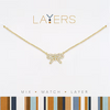 Gold necklace with a bow-shaped pendant on a white background, featuring the 'Layers' brand.