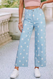 Person wearing light blue pants with white polka dots outdoors.