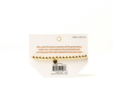 Bracelet packaging with gold beads on a white background