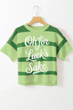 Green striped shirt with text on a hanger against a white background