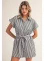 Woman wearing a striped dress with a belt in a casual setting
