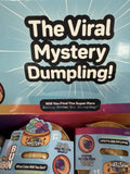 Product packaging with 'The Viral Mystery Dumpling!' text and colorful design.