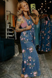 Woman taking a selfie in a floral denim jumpsuit in a clothing store.