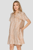 Woman wearing a beige patterned dress on a white background