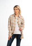 Woman wearing a plaid jacket over a white top and jeans on a white background