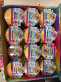 Box of 'Bun' mystery cake sets with colorful packaging.