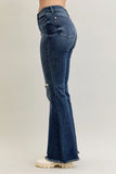 Blue flared jeans worn by a person on a light gray background