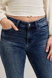 Person wearing blue jeans with a neutral background