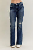 Blue jeans with a subtle distressing detail on a plain background
