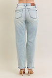 Light blue jeans worn by a person on a beige background