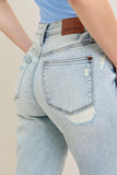 Light blue jeans with a brand label on a neutral background