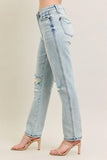 Light blue jeans with a distressed design worn by a person on a beige background